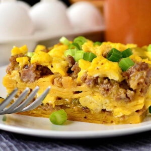 slice of breakfast taco casserole on a plate with a fork