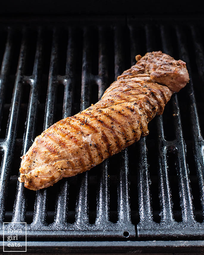 pork tenderloin on a grill grate