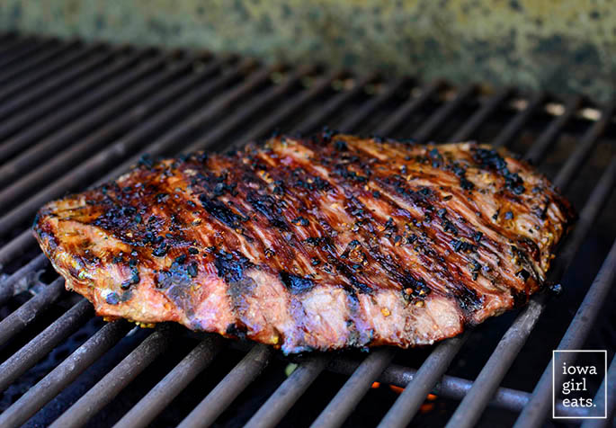 a steak grilling on a grill
