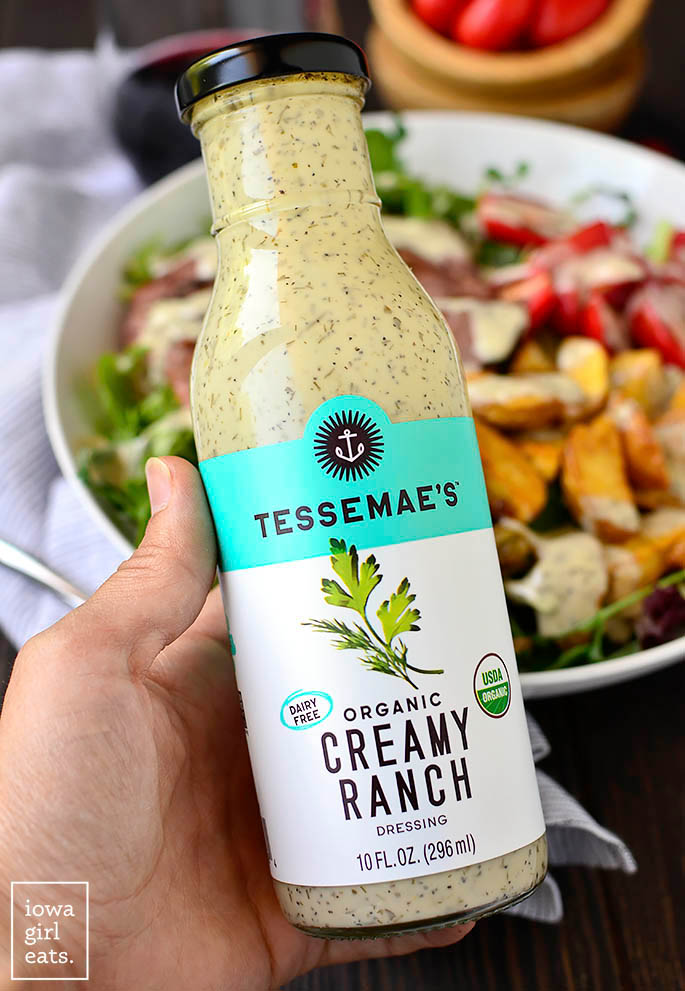 tessemae's creamy ranch dressing in front of a salad bowl