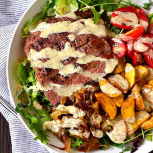 overhead photo of steak and potatoes on a salad