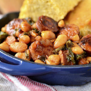 Skillet BBQ Sausage, Beans and Greens will be on the table in under 30 minutes. This easy, gluten-free dinner recipe calls for just 7 ingredients and is packed with protein, vitamins, and minerals! | iowagirleats.com