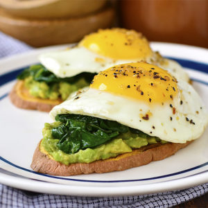Get your day started with a punch of protein, healthy fats and vegetables! Avocado, Egg and Spinach Sweet Potato Toasts are a delicious gluten-free breakfast recipe. | iowagirleats.com