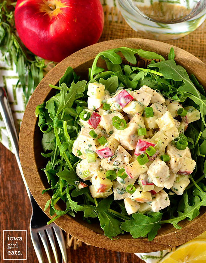 apple tarragon chicken salad scooped over a bowl of lettuce