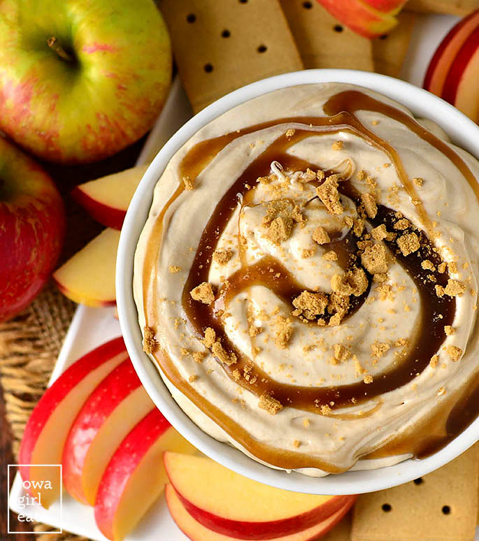 overhead photo of a bowl of caramel apple cheesecake dip with sliced apples