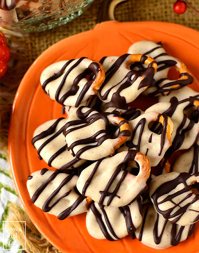 pumpkin spice chocolate covered pretzels on a plate