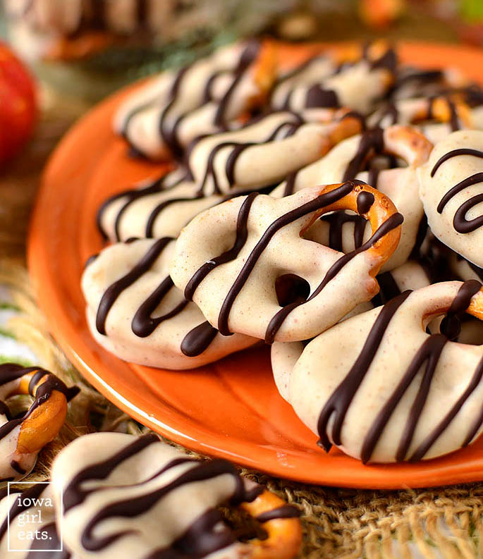 pumpkin spice chocolate covered pretzels on a pumpkin shaped plate