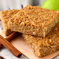 Apple Cinnamon Oatmeal bars stacked on top of each other on a plate