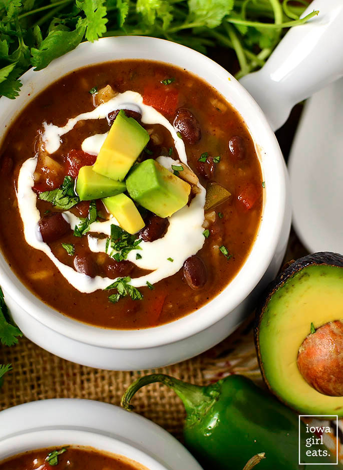 slow cooker black bean and rice soup in a bowl with fresh avocado