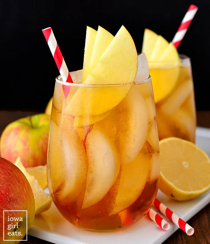 maple bourbon cider in a glass with apple garnish