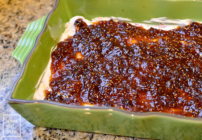 fig jam spread over goat cheese in a baking dish