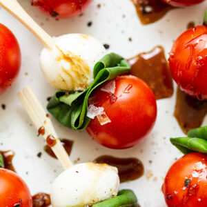 caprese skewer with balsamic drizzle on a serving platter
