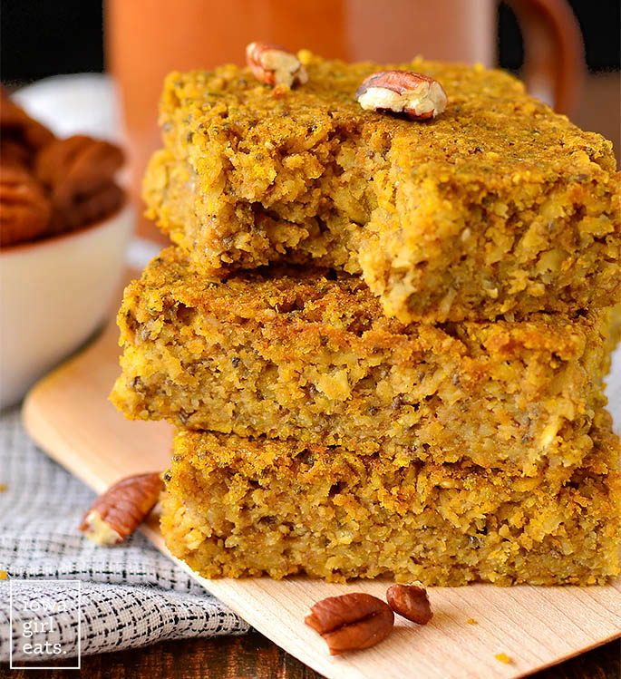 stack of maple pumpkin oatmeal breakfast bars with a bite taken out
