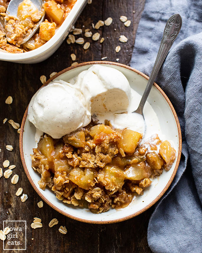 gluten free apple crisp in a bowl with ice cream