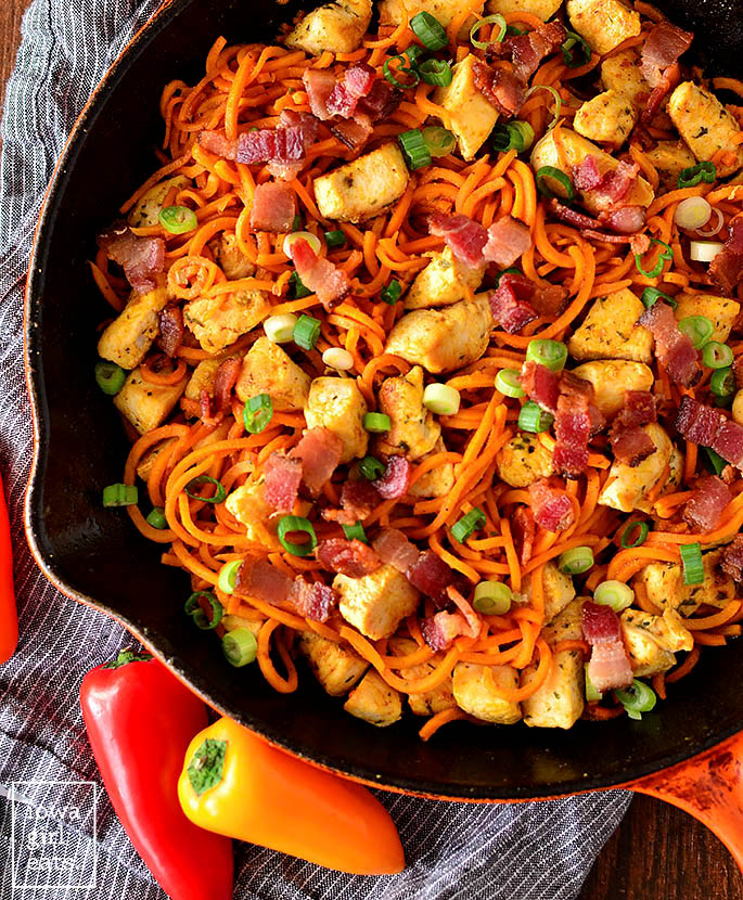 overhead photo of buffalo chicken bacon and sweet potato noodle skillet
