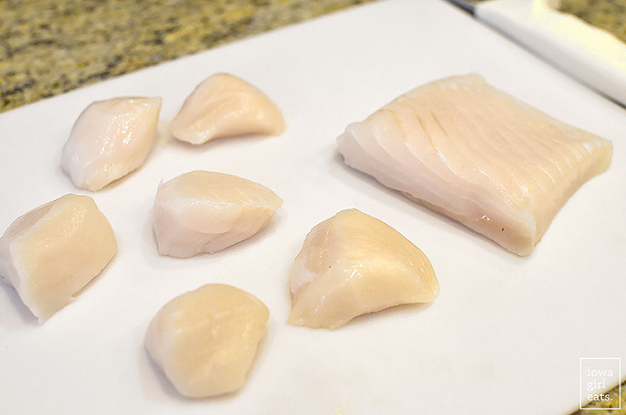scallops and halibut on a cutting board