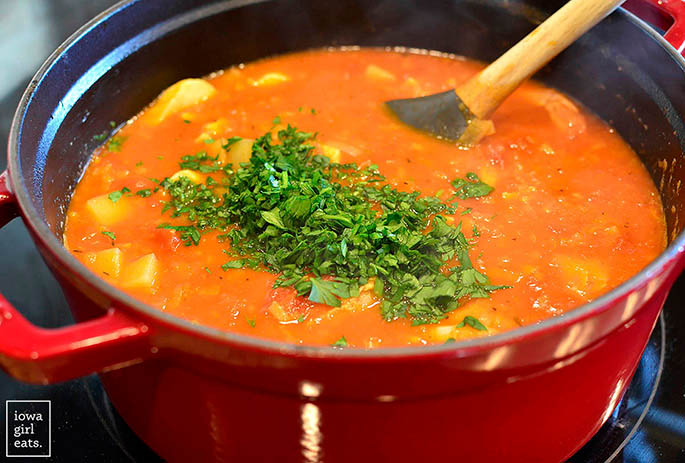 pot of seafood stew with fresh parsley
