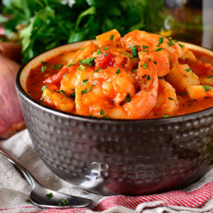 seafood stew in a bowl with a spoon
