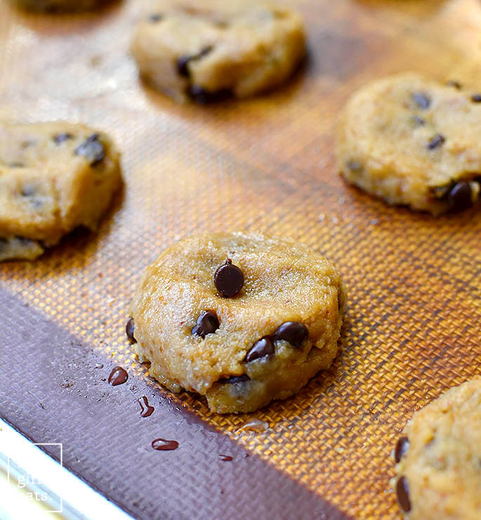 raw almond flour chocolate chip cookies on a baking sheet