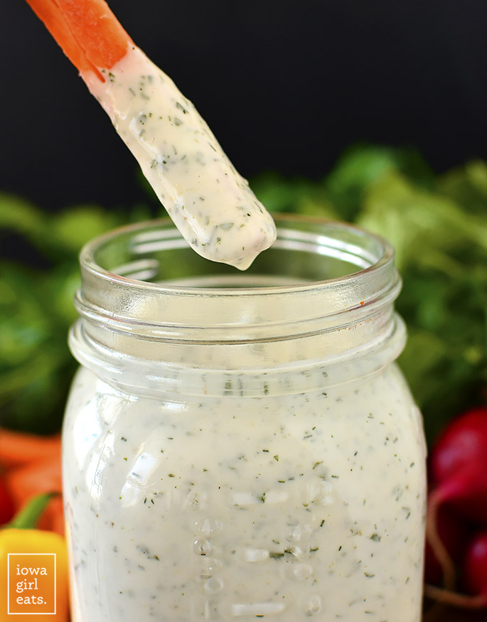 Carrot stick dipping into Homemade Ranch Dressing that's gluten-free and vegan too.