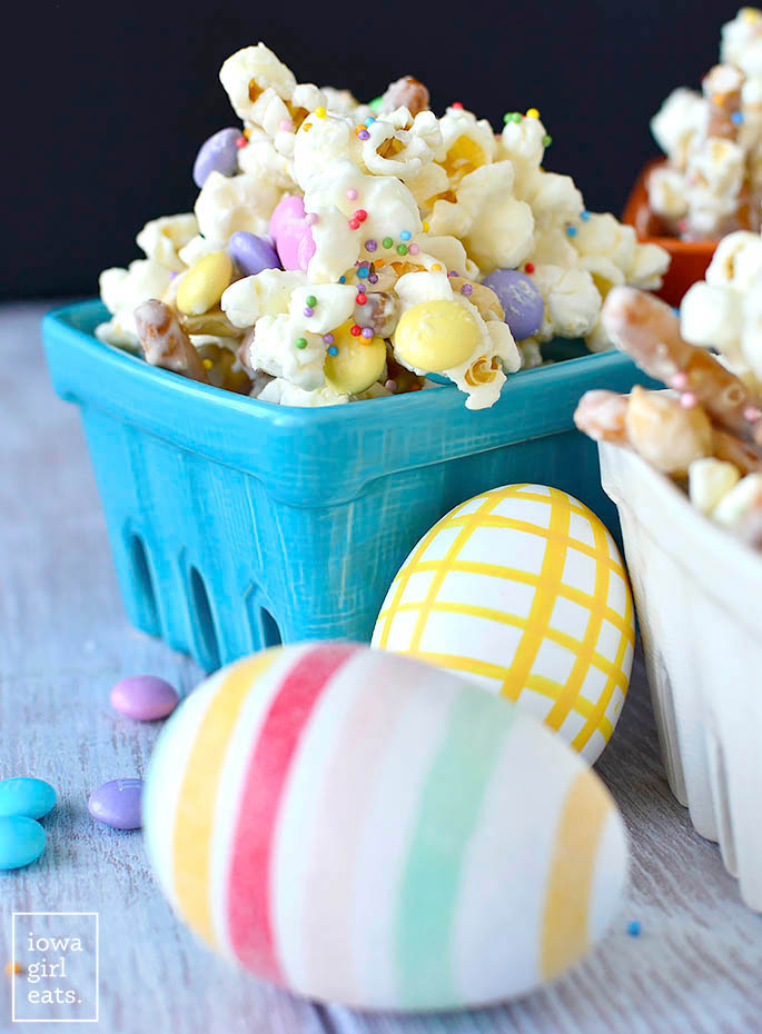 colorful easter eggs in front of a bowl of bunny munch
