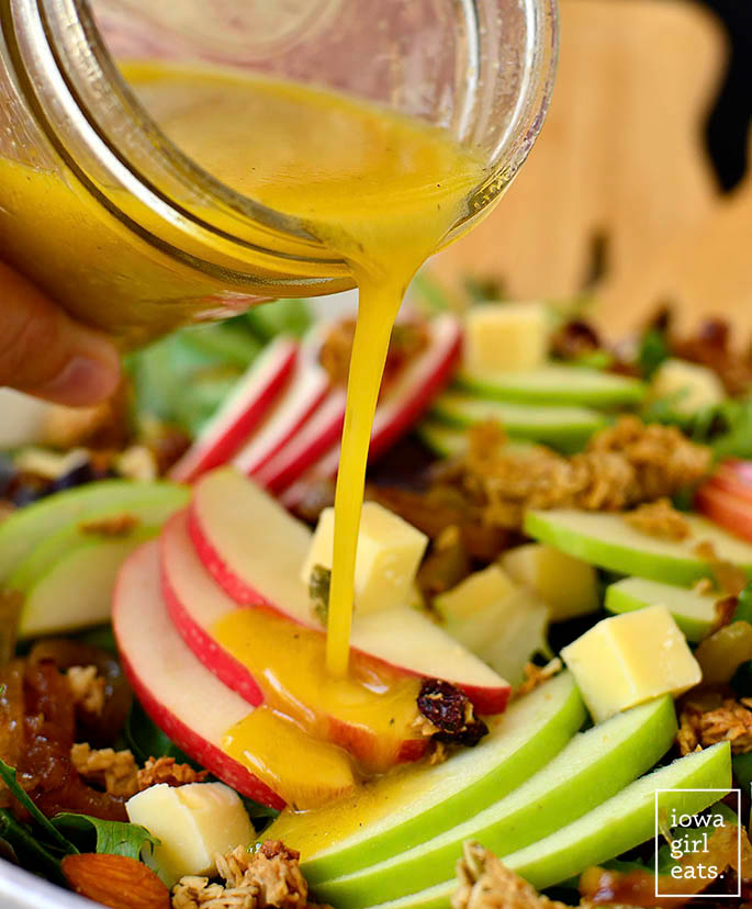 Maple Vinaigrette being poured onto Apple Orchard Salad