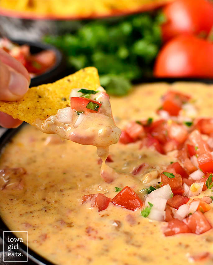 Chip dipping into Chorizo Queso Dip