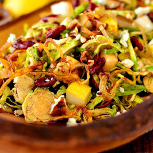Fall shredded brussels sprouts salad in a wooden serving bowl