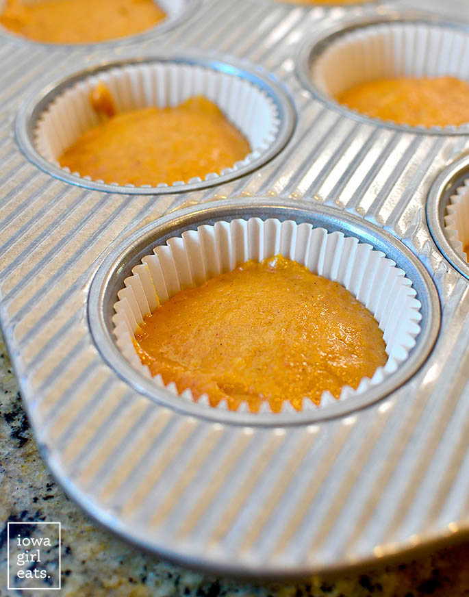 pumpkin cupcake batter in a muffin tin