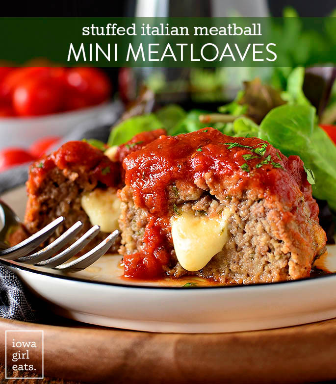 Stuffed Italian Meatball Mini aMeatloaves cut in half with cheese oozing out.