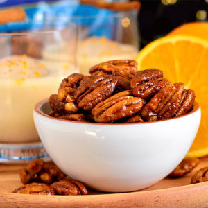 orange candied pecans in a dish
