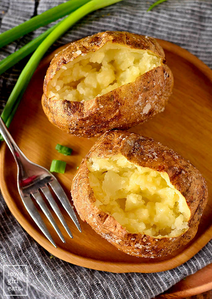 Two baked potatoes fluffed and buttered