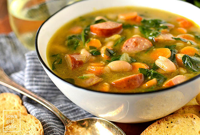 Bowl of soup with beans, sausage, and spinach