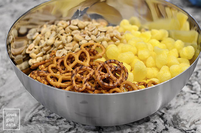 a bowl of puffcorn pretzels and peanuts on a counter