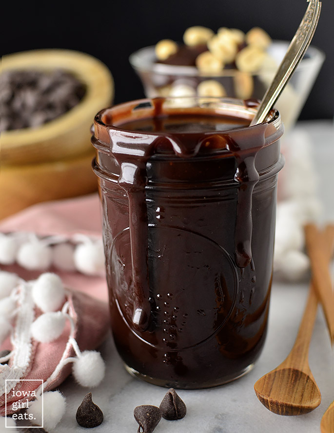 homemade hot fudge sauce in a jar with a spoon
