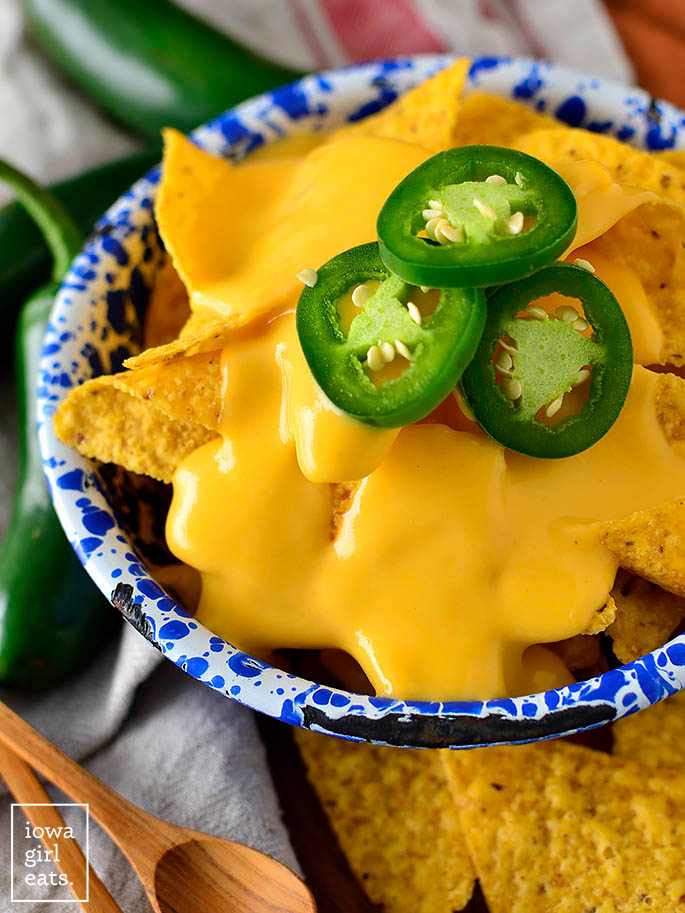 Tortilla chips with homemade nacho cheese sauce on top