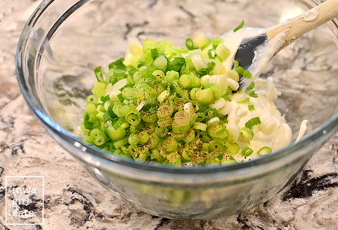 whipped feta dip with green onions and dill in a mixing bowl