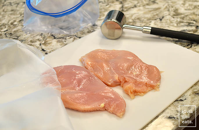 chicken breasts pounded out on a cutting board