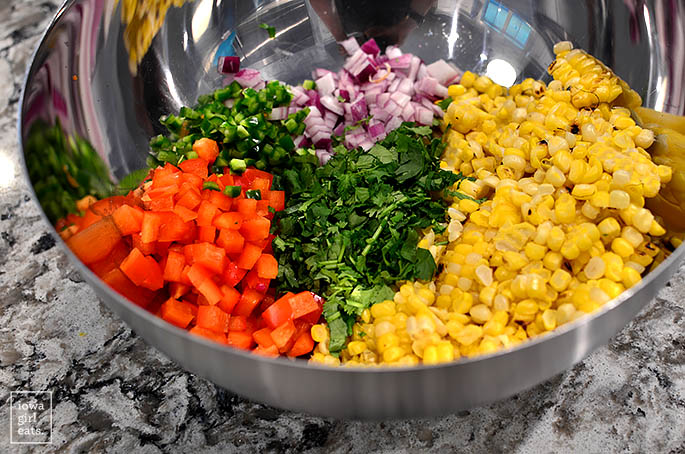 ingredients for southwest grilled corn salad in a mixing bowl