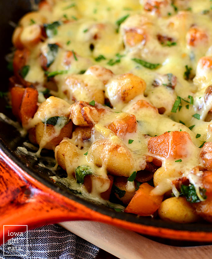 Cast iron skillet of Cheesy Bacon Butternut Squash and Caramelized Onion Gnocchi