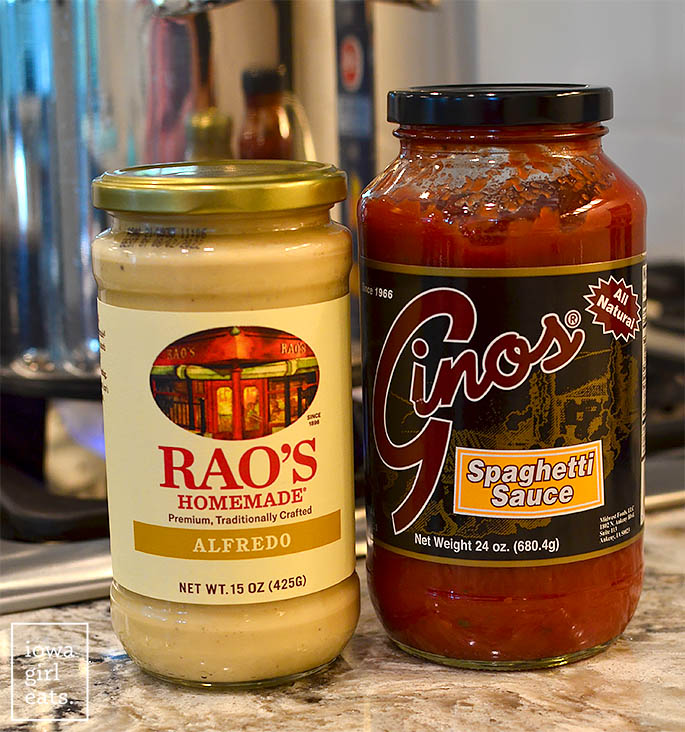 jars of marinara sauce and alfredo sauce sitting on the counter