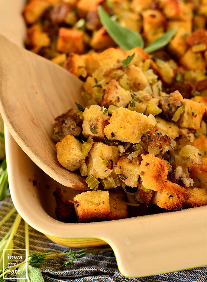 spoon scooping out gluten free bread stuffing from a baking dish