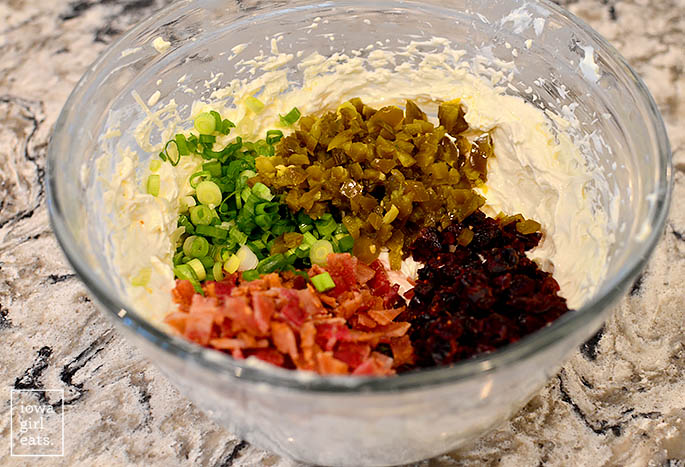 ingredients for cranberry bacon jalapeno dip in a mixing bowl