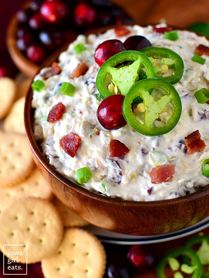 bowl of cranberry jalapeno bacon dip with cranberries and jalapenos on top