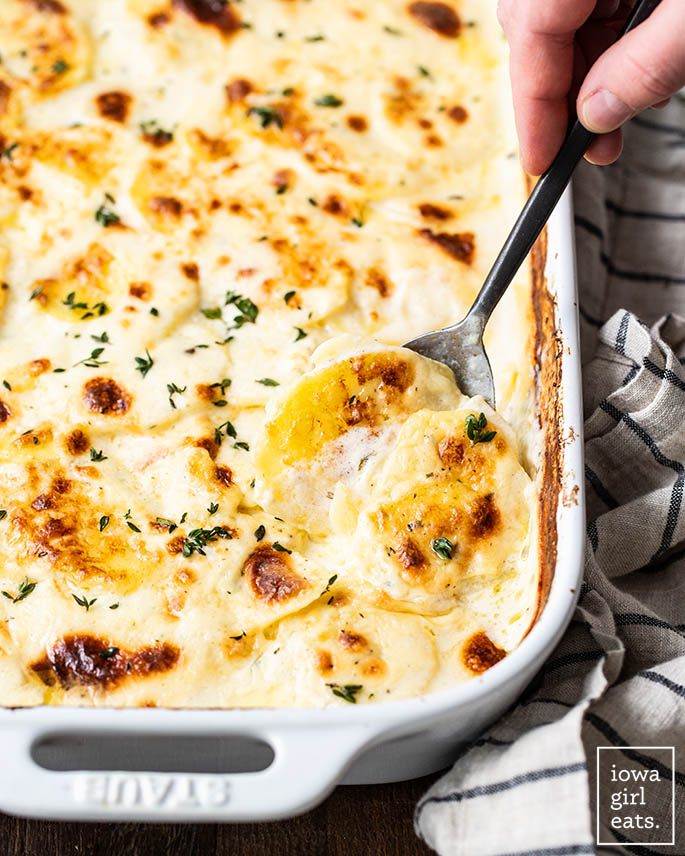 spoon scooping up gluten free scalloped potatoes