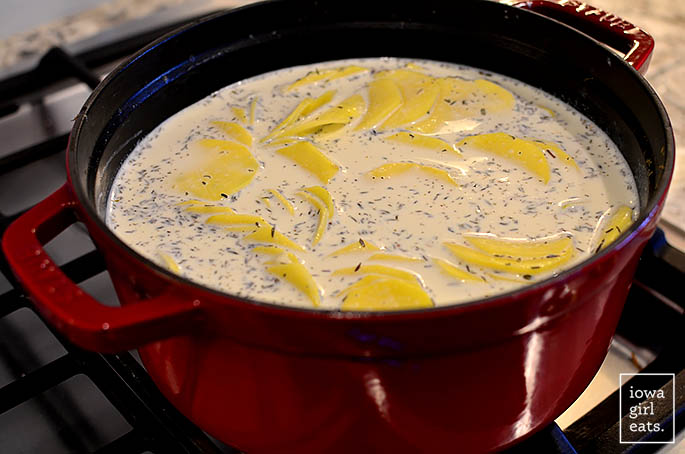 sliced otatoe in cream in a pot