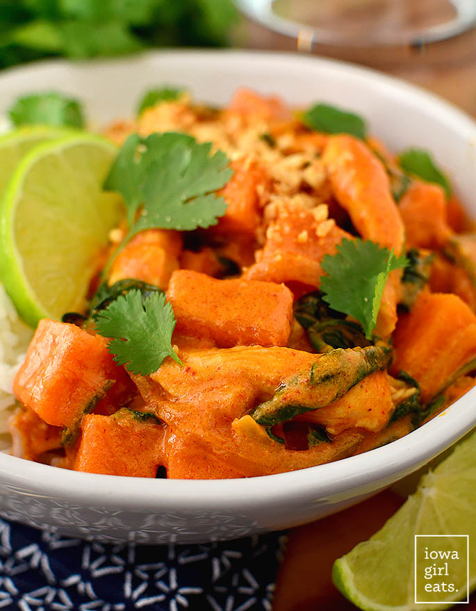 sweet potato coconut curry in a bowl with cilantro and minced peanuts