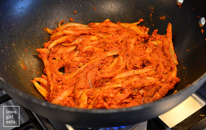 red thai chili paste with onions in a wok