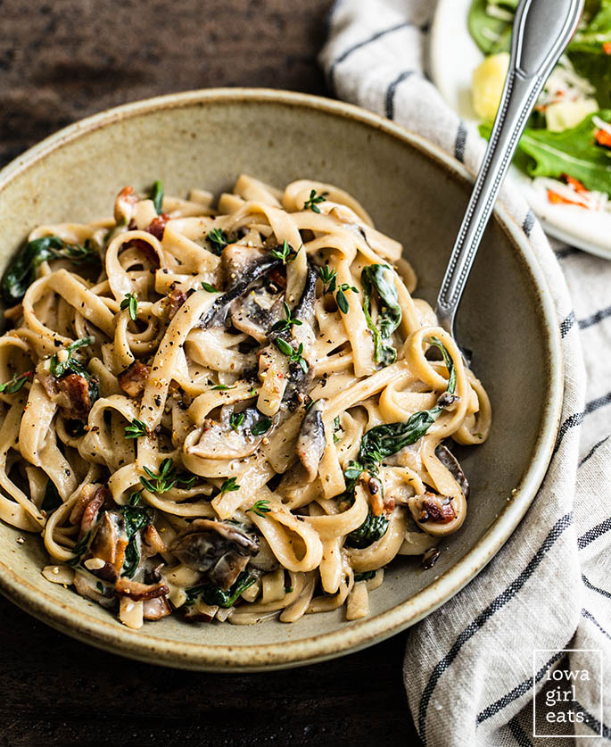 bowl of creamy parmesan mushroom pasta with a fork inside