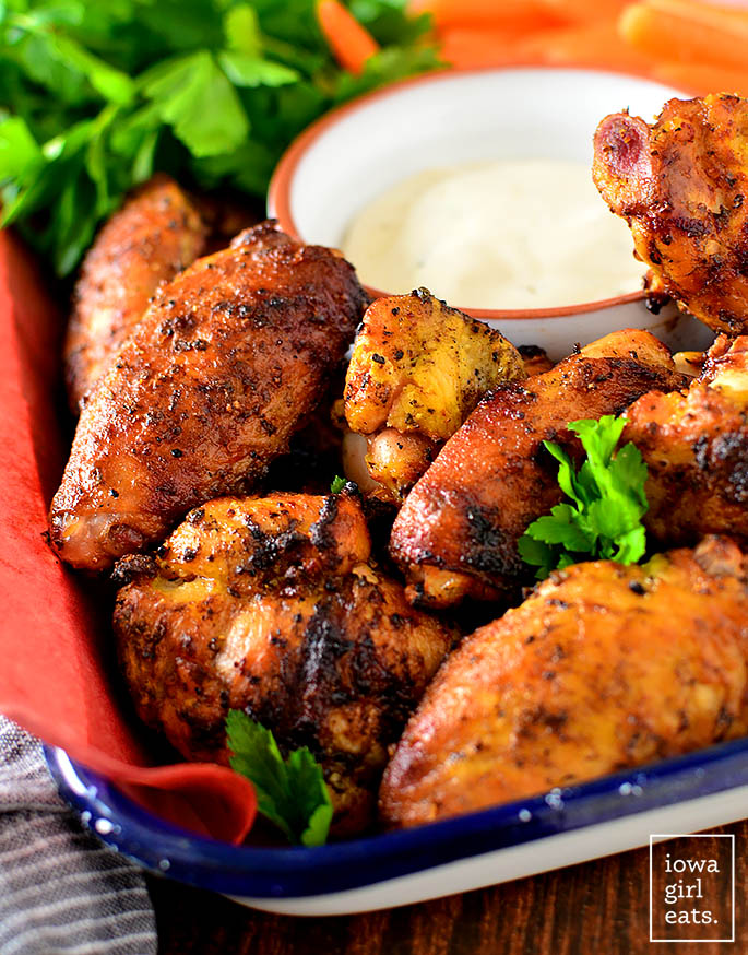 crispy smoked chicken wings in a basket with dipping sauce